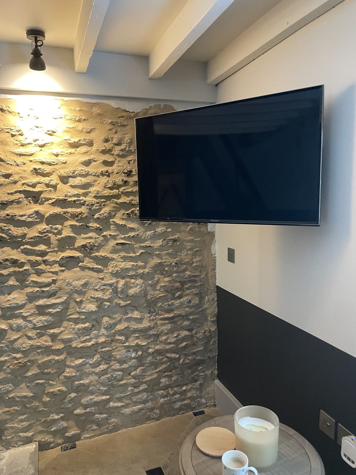 Stone-walled room with ceiling spotlights