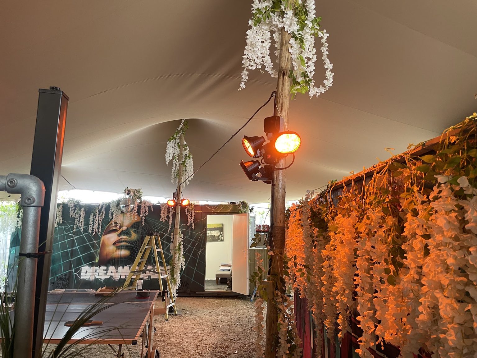 Garden marquee lit with festoon lights and a floodlight