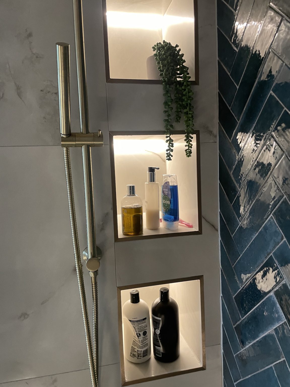 Shower wall with three lit niches